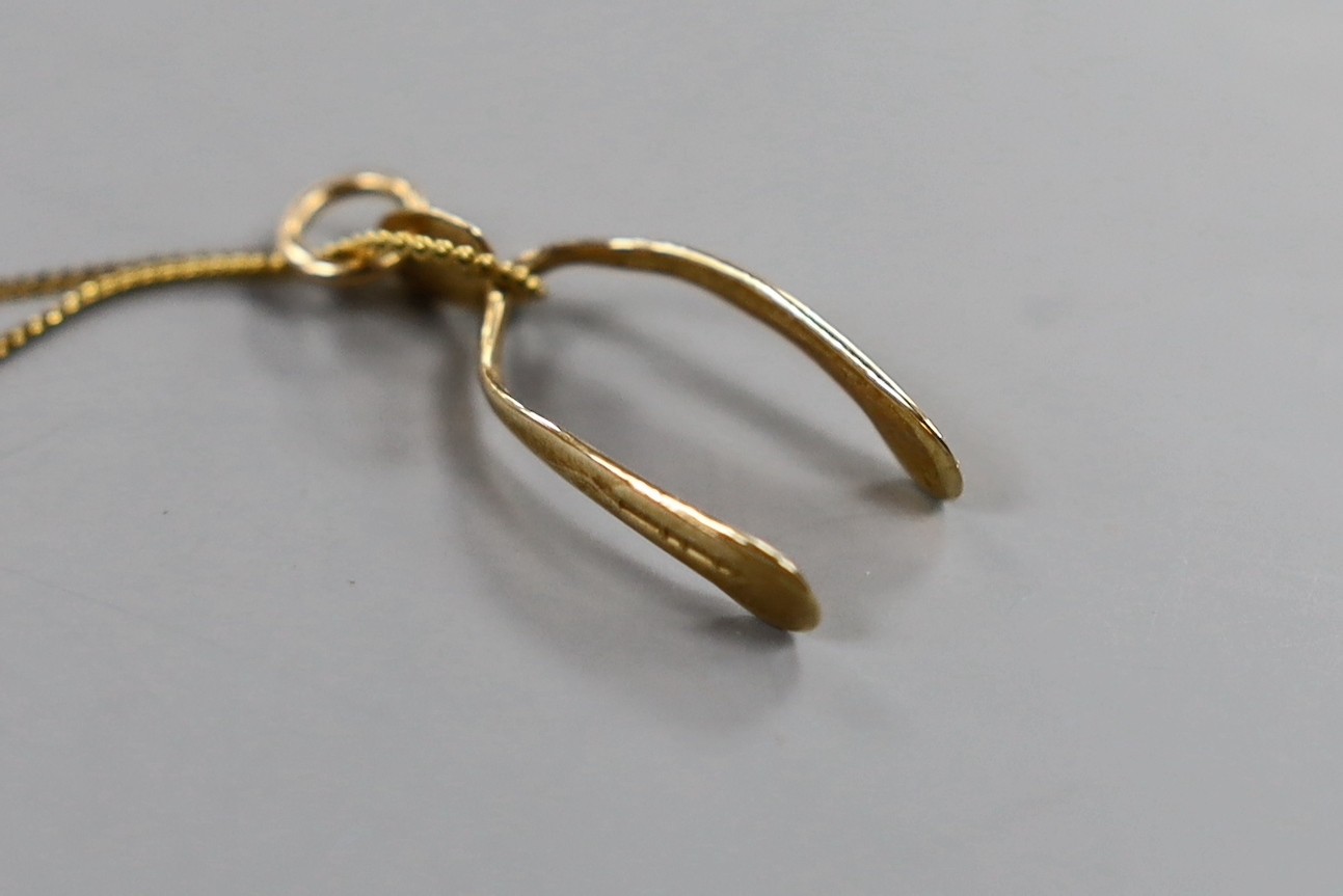 A modern 9ct gold wish bone pendant on a 9ct chain and a quantity of assorted costume jewellery, coins, etc.